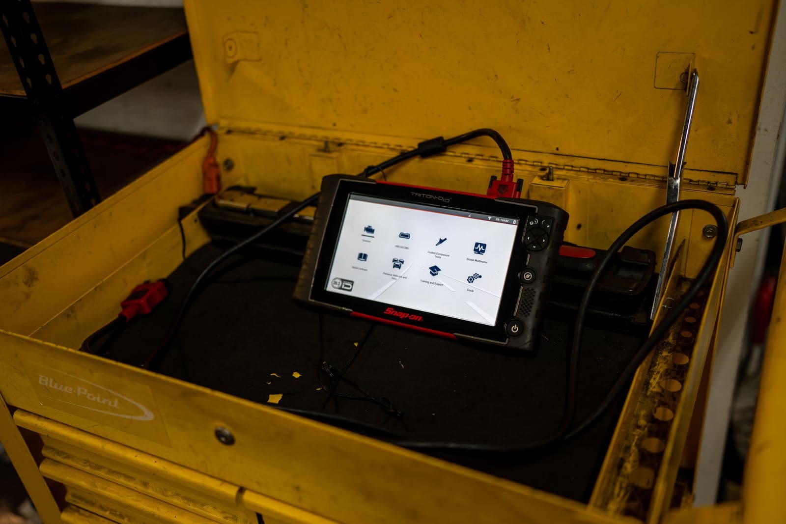 Diagnostic scan tool on a tool cart in the shop