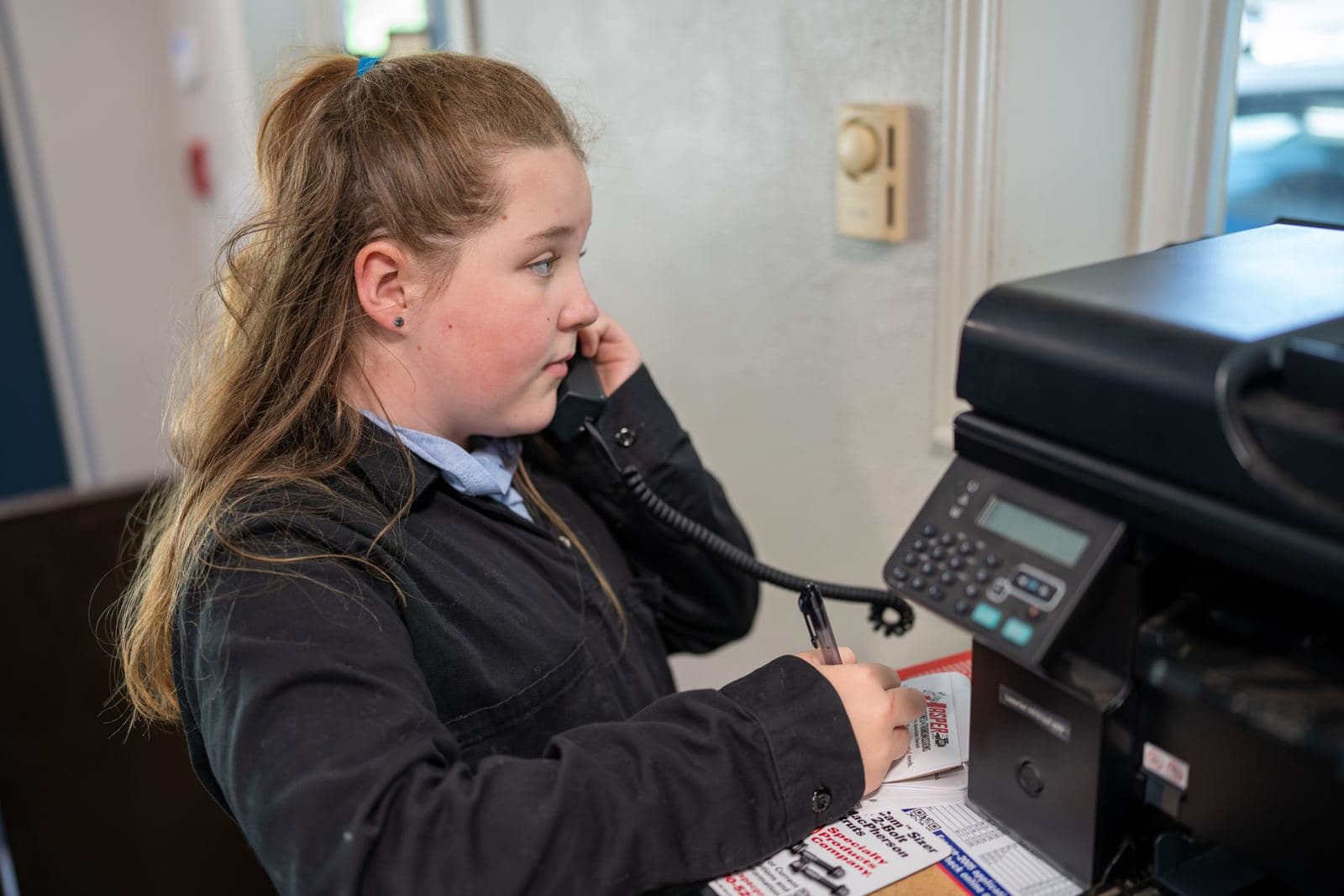 Service advisor answering the phone at the front desk