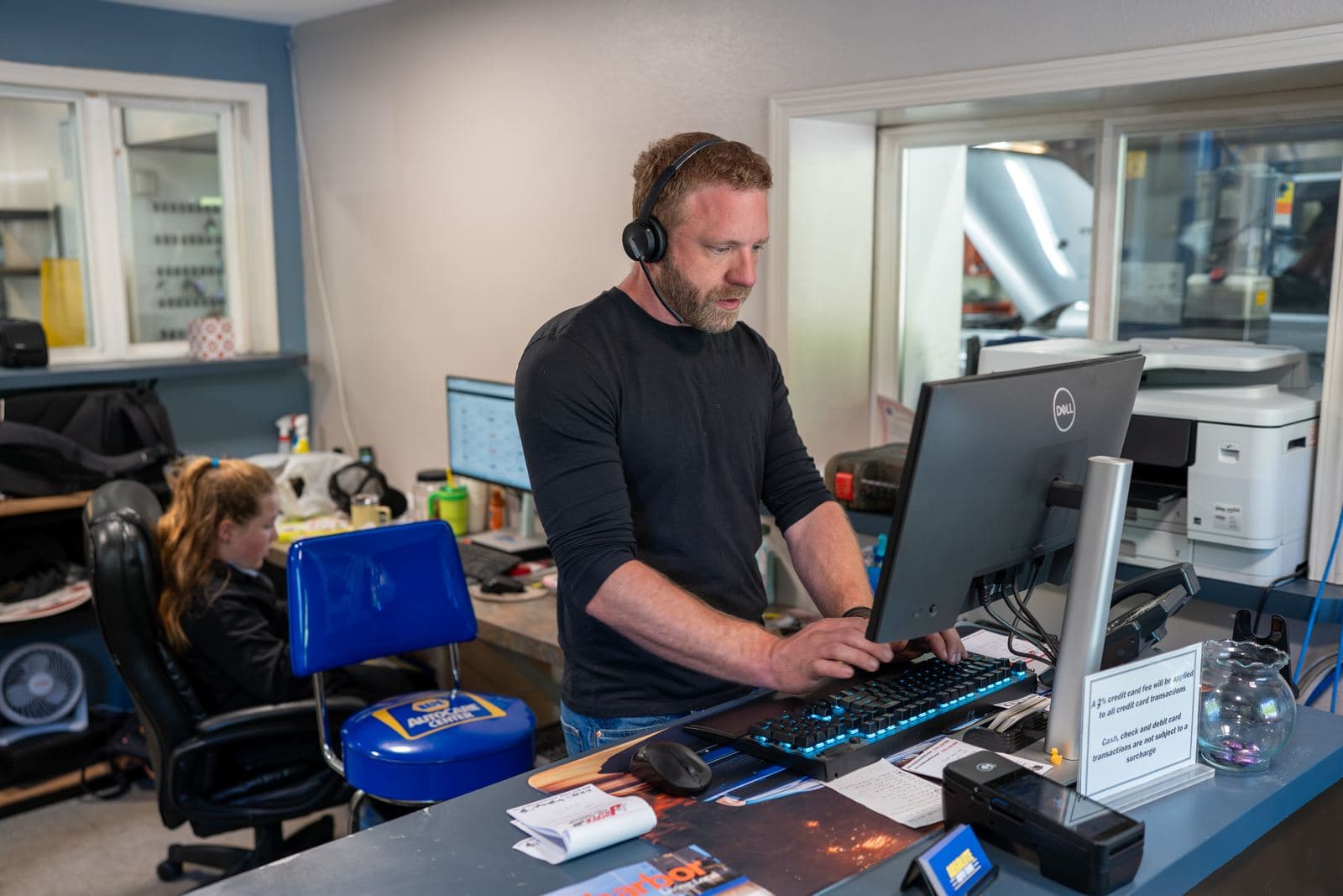 Front office staff scheduling appointments at the service desk