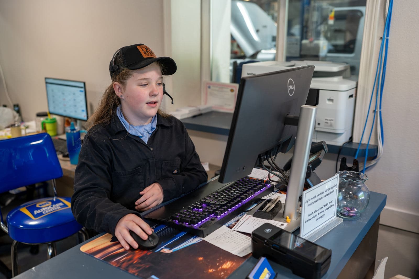 Front office staff scheduling appointments at the service desk