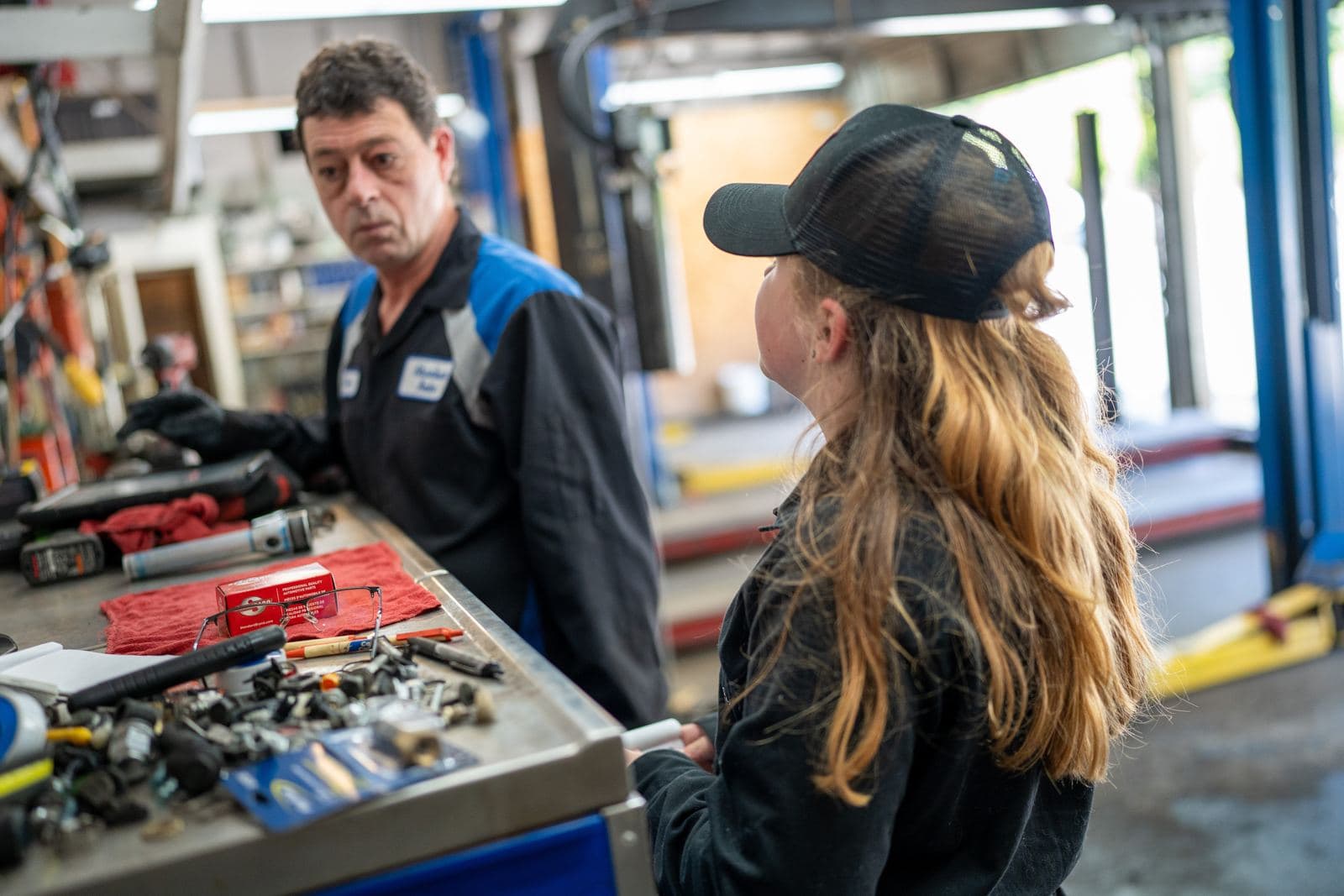 Technicians sorting parts at the workbench