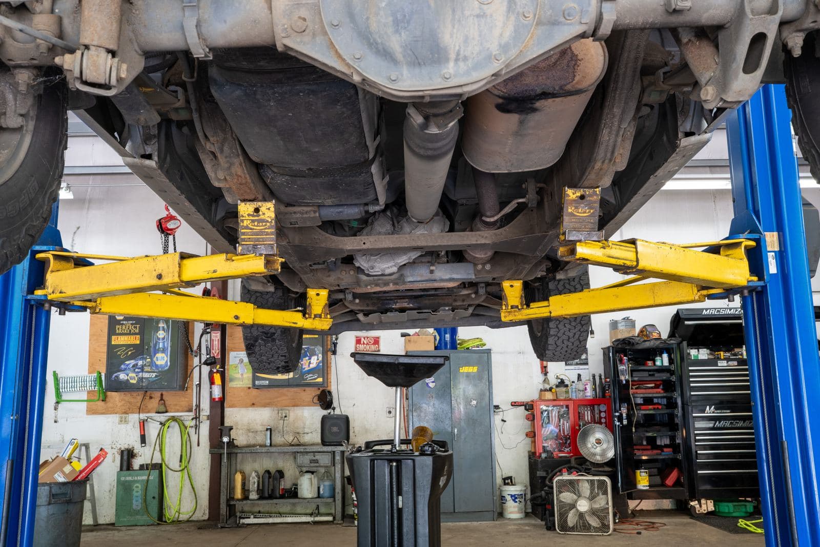 Wide view of a service bay with a truck on the lift