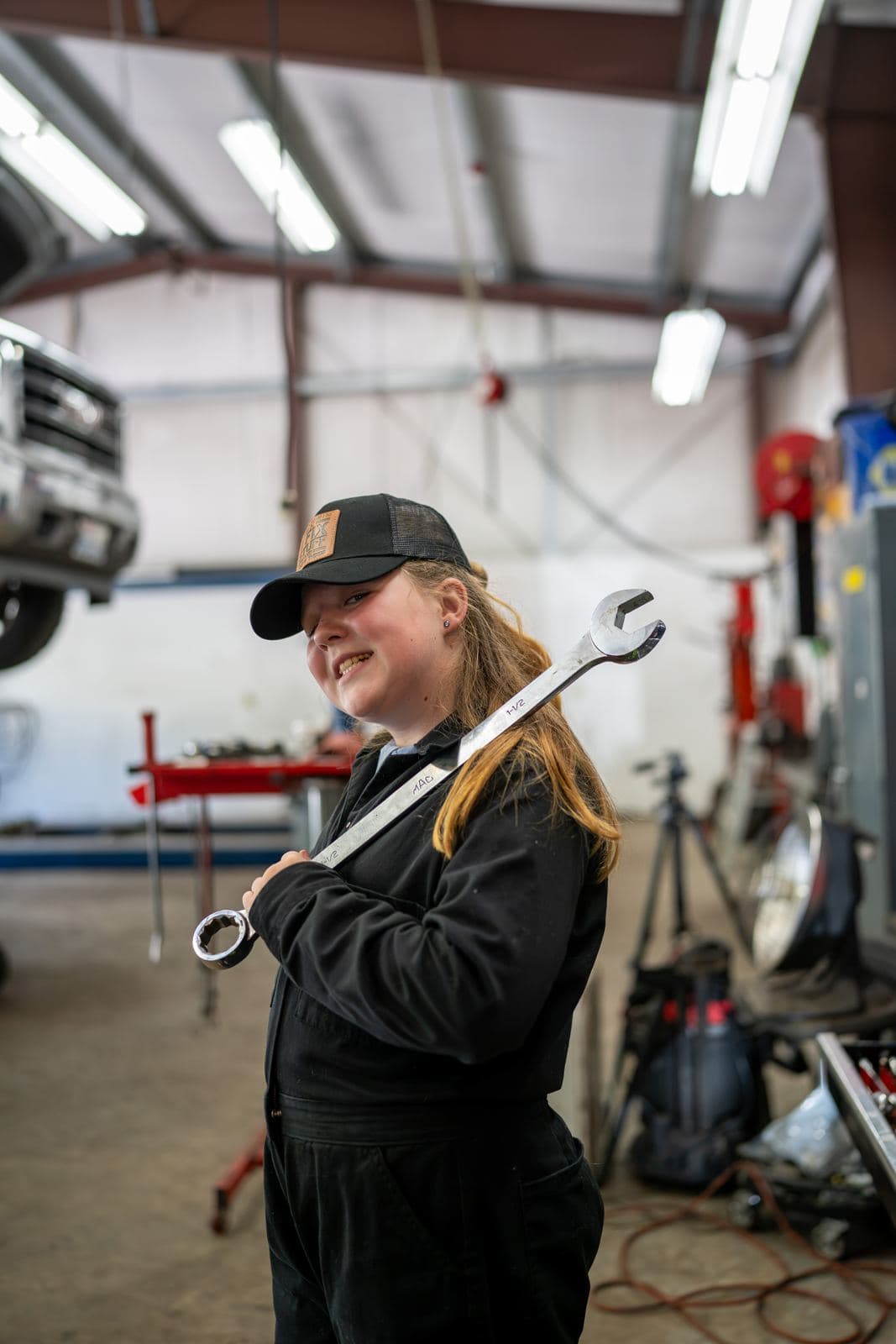 Technician holding a large wrench in the shop