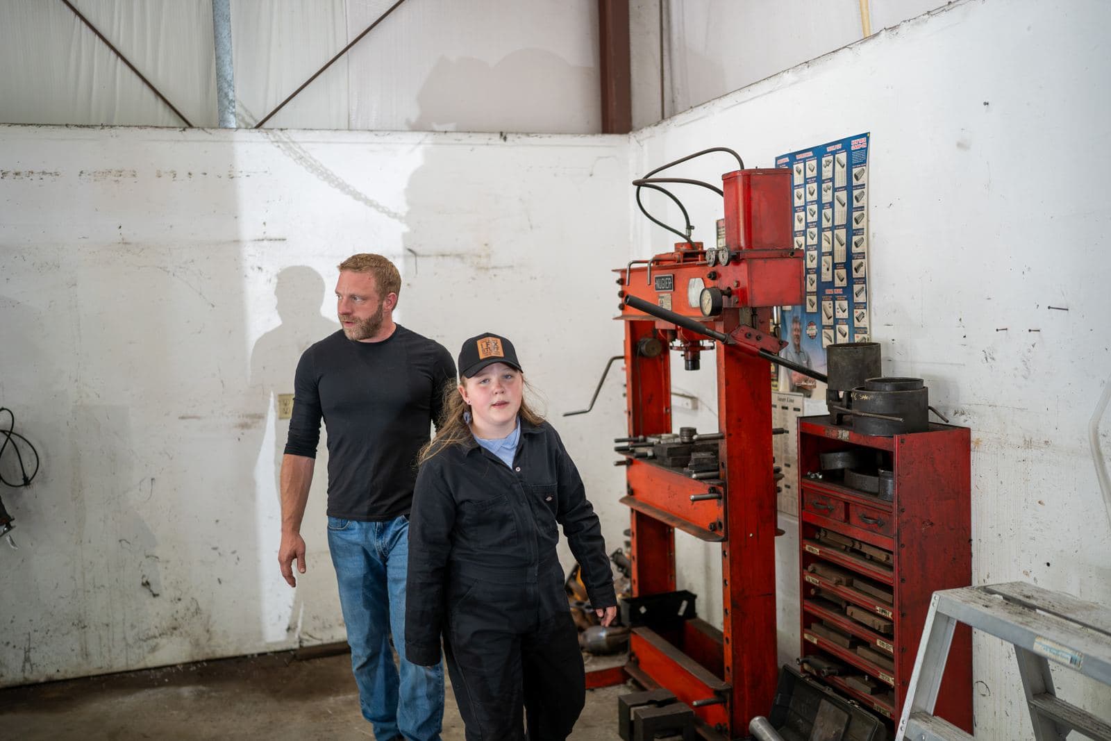 Shop owner and technician walking through the shop