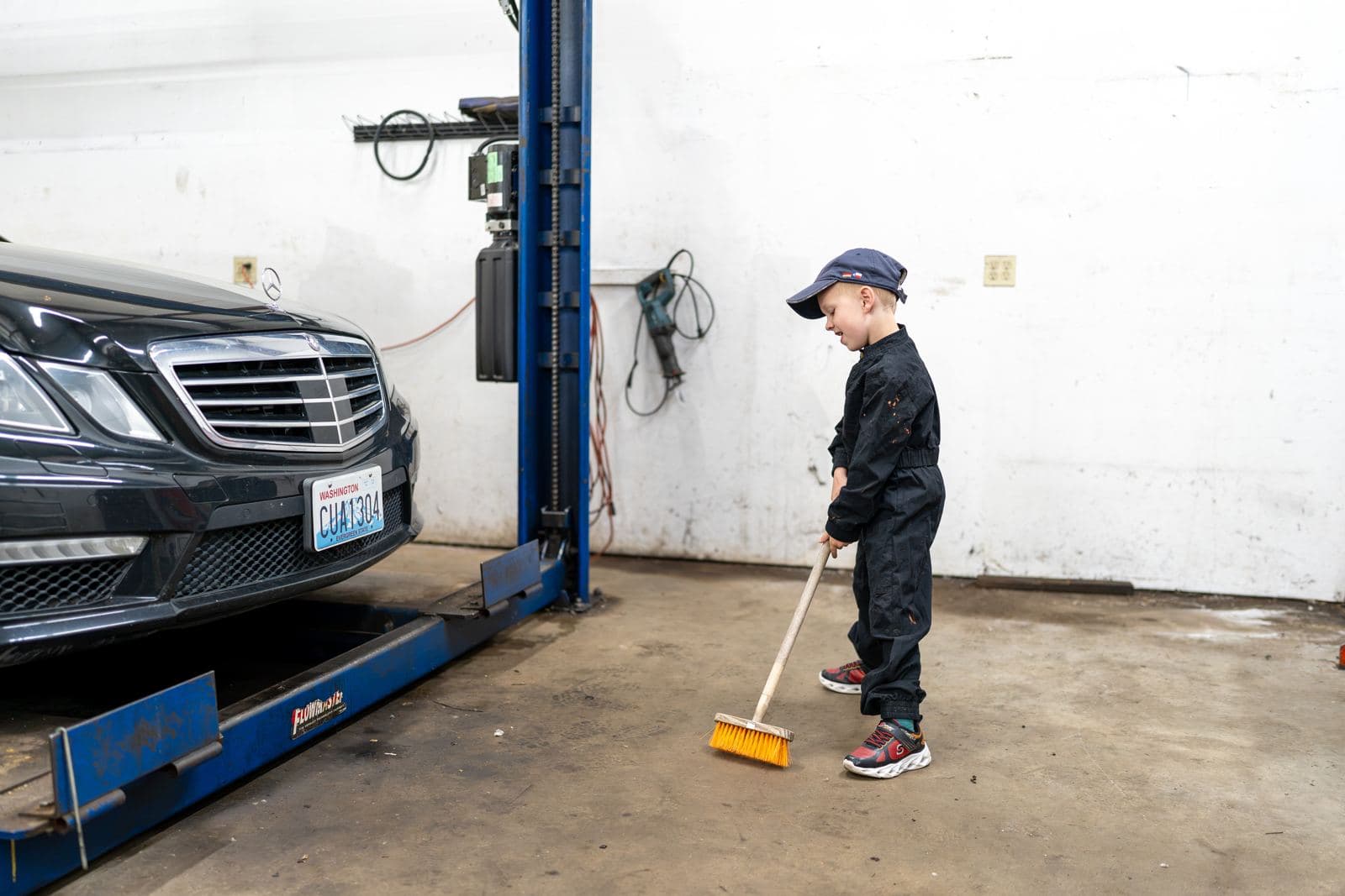 Junior crew members sweeping the shop floor