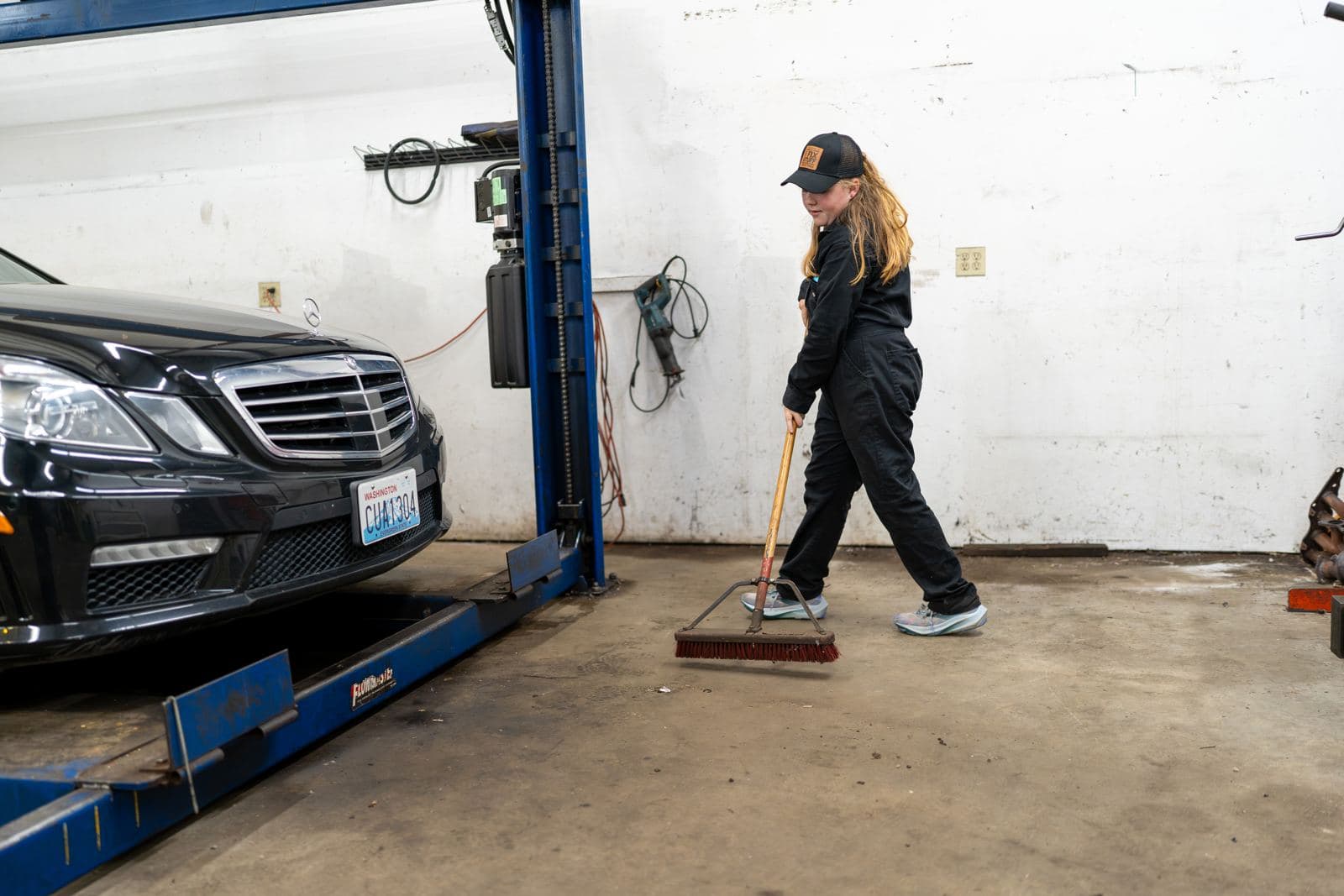 Junior crew members sweeping the shop floor