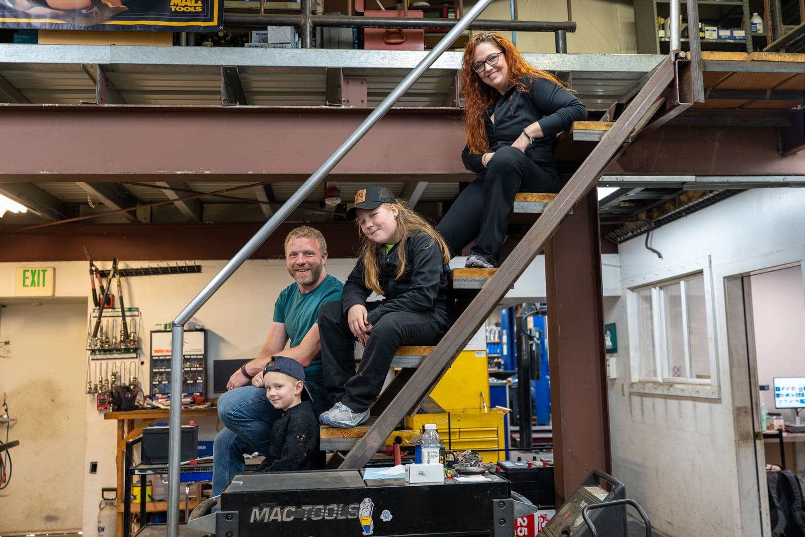 The Absolute Auto Care family on the shop stairs