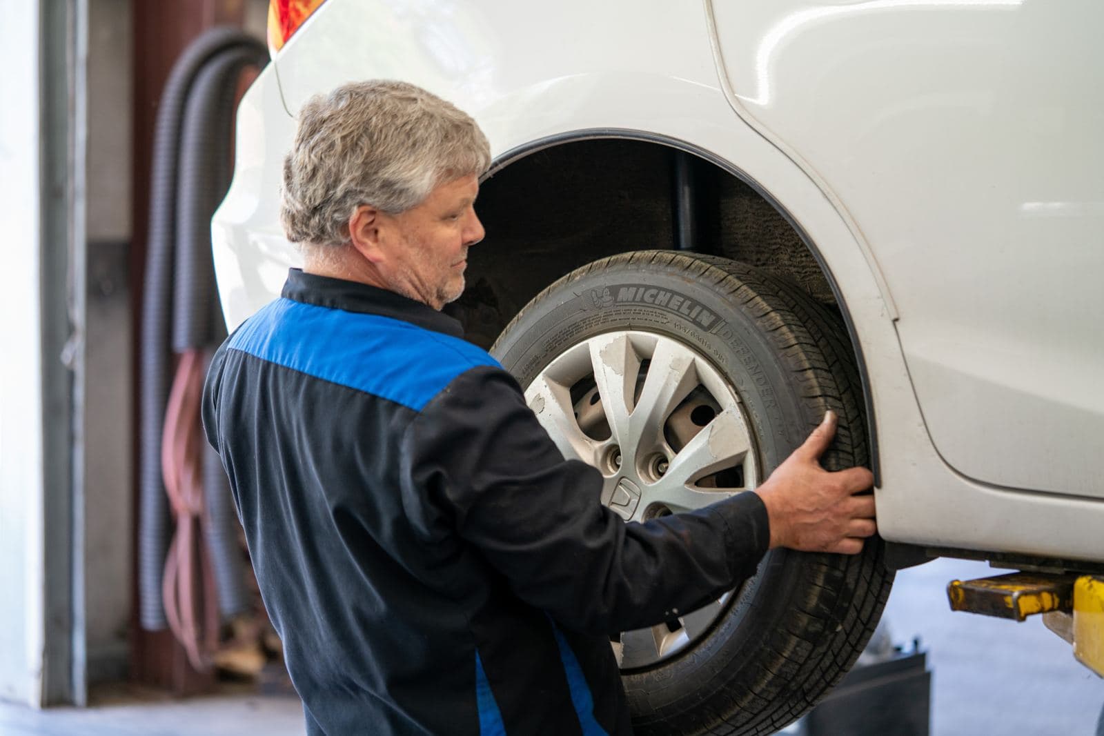 Technician reinstalling a wheel after brake service