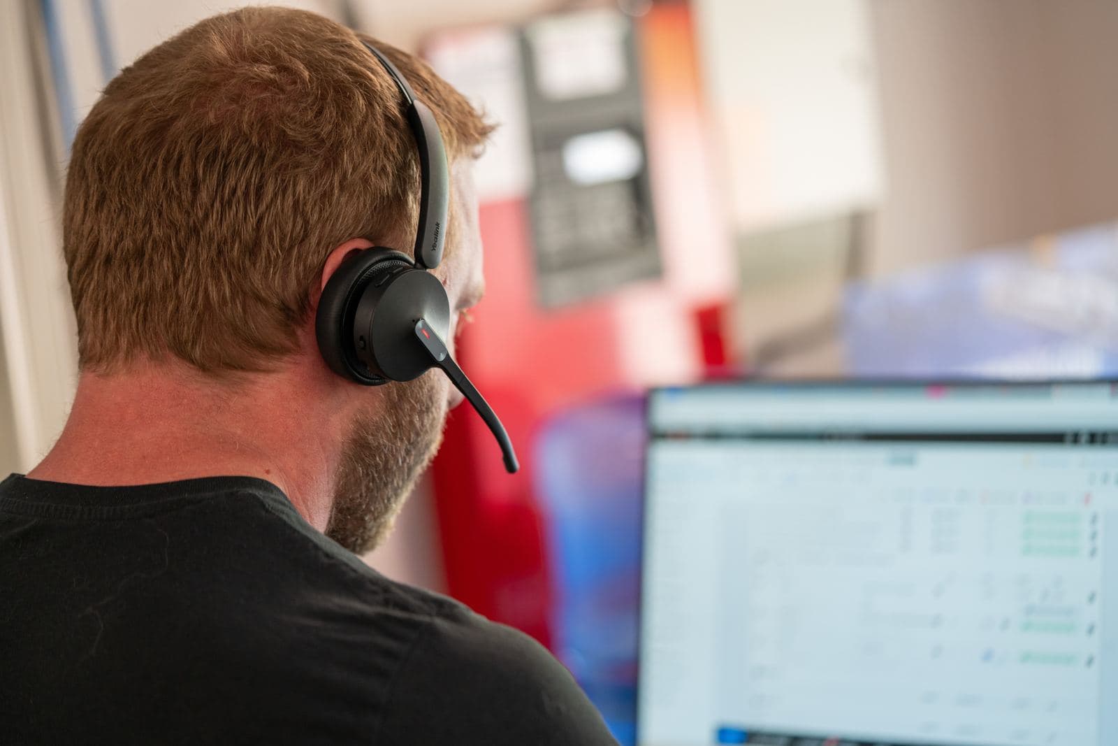 Service advisor on a headset at the front desk