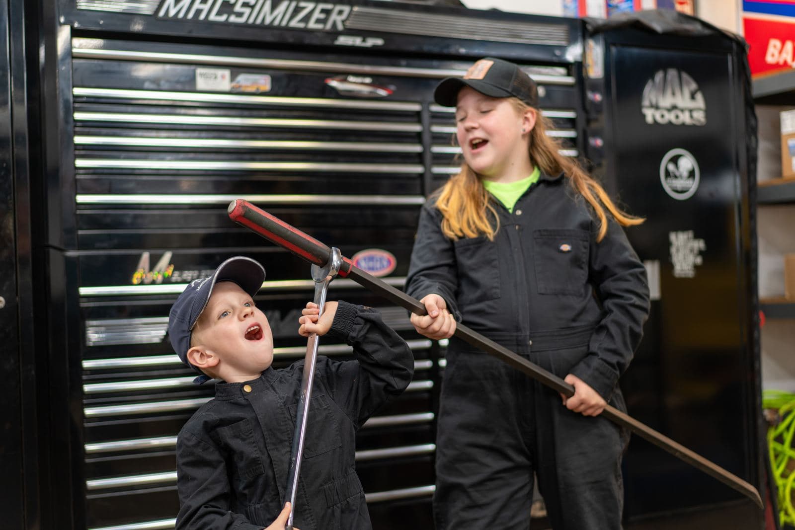 Junior crew members with a pry bar by the tool chest