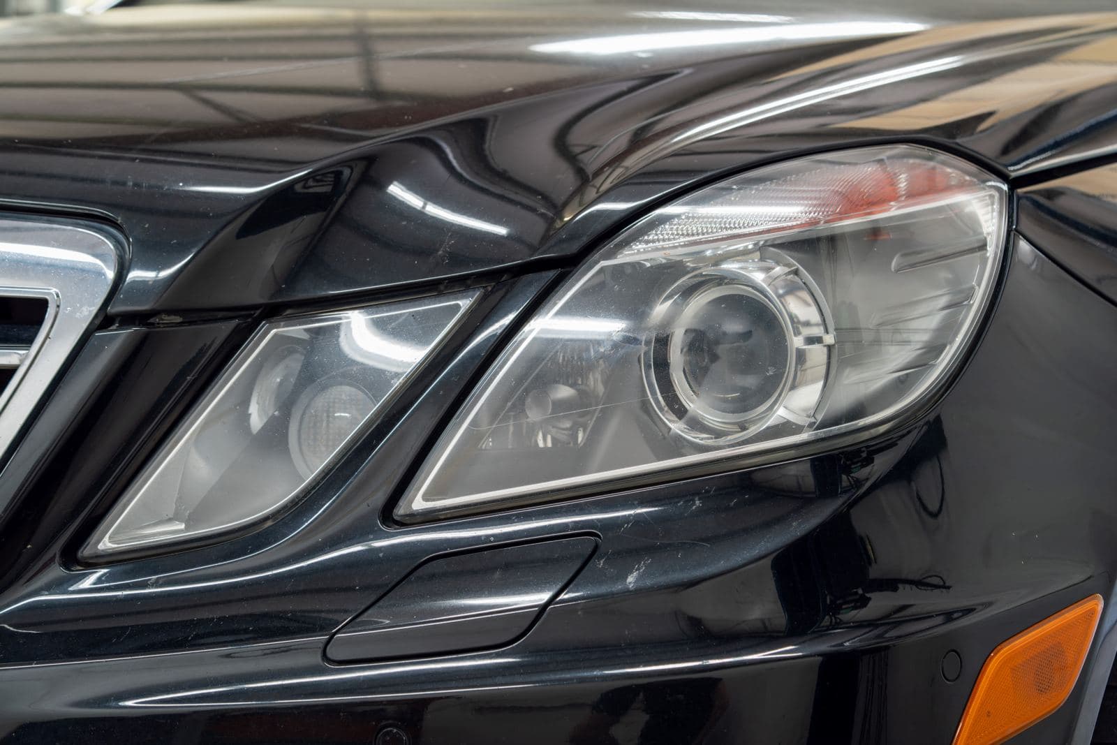 Mercedes-Benz emblem and headlight detail in the shop