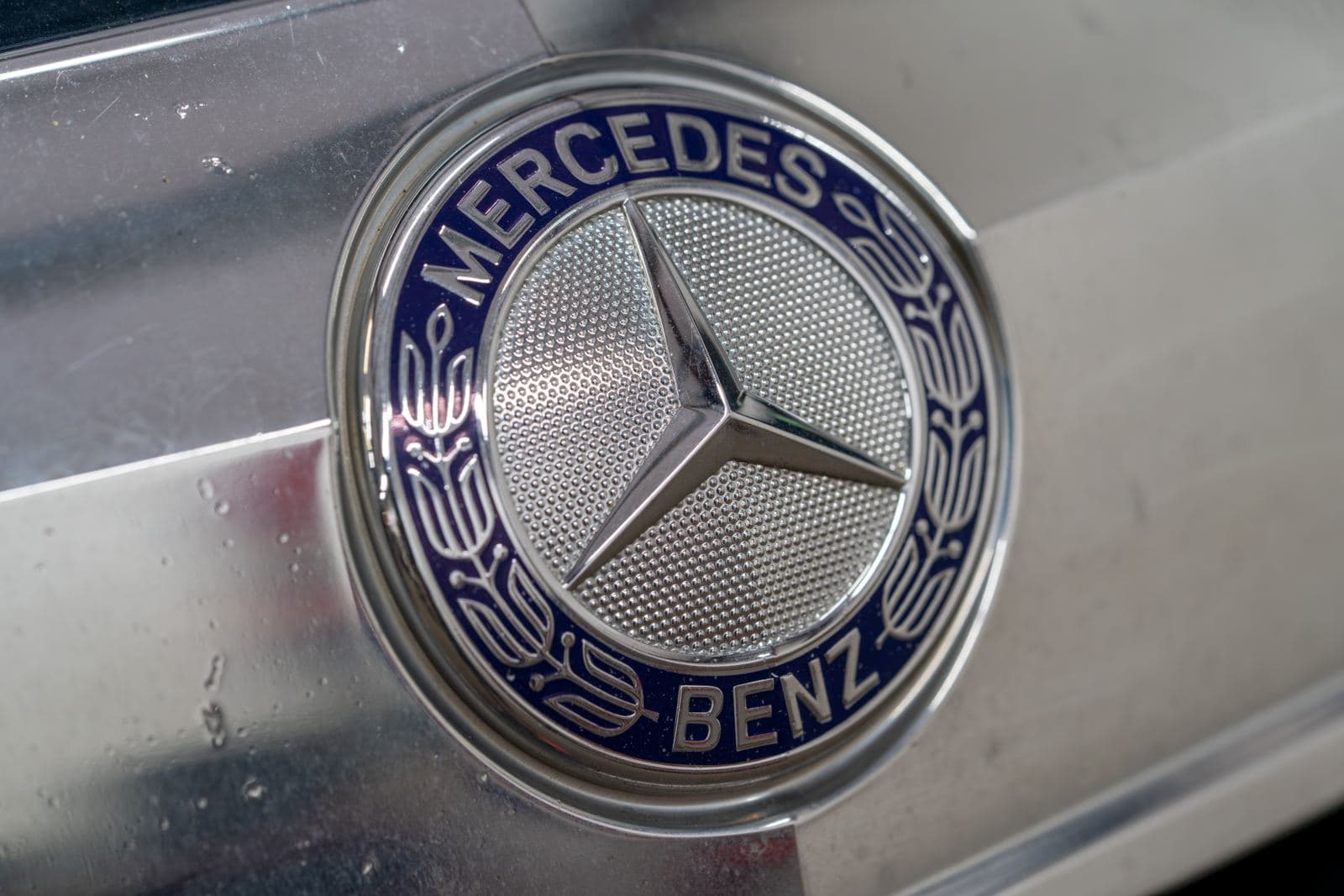Mercedes-Benz emblem and headlight detail in the shop